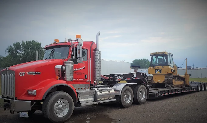 Red Kenworth T800 tractor with lowboy trailer hauling a Cat dozer