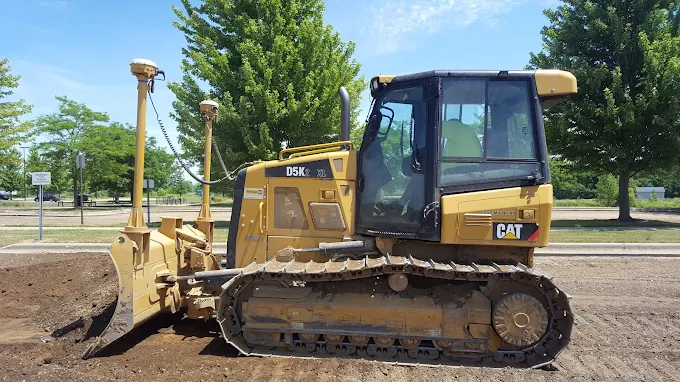 Cat dozer benching a large pond excavation